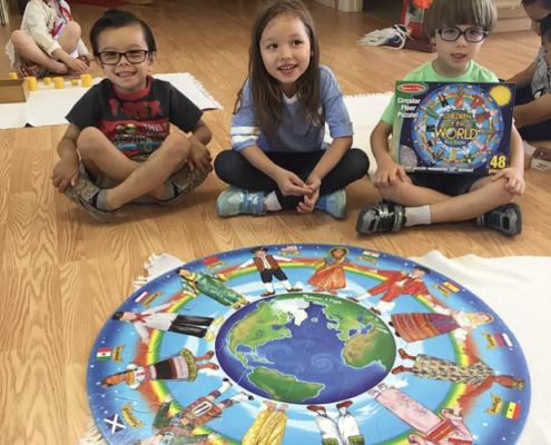 students exploring the solar system using Montessori cosmic education materials