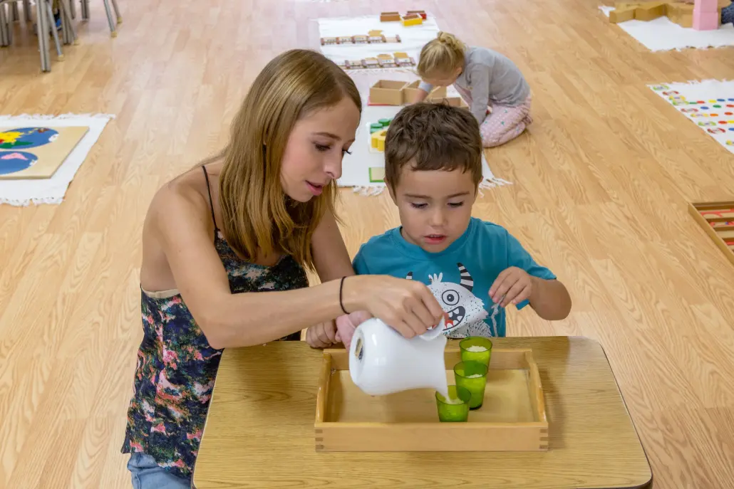 a child exploring size gradation with Montessori pink tower materials