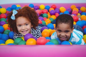 a child developing practical life skills with a Montessori pouring activity