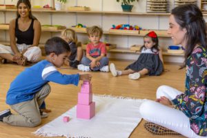 students using Montessori sensorial materials to explore size and shape differences